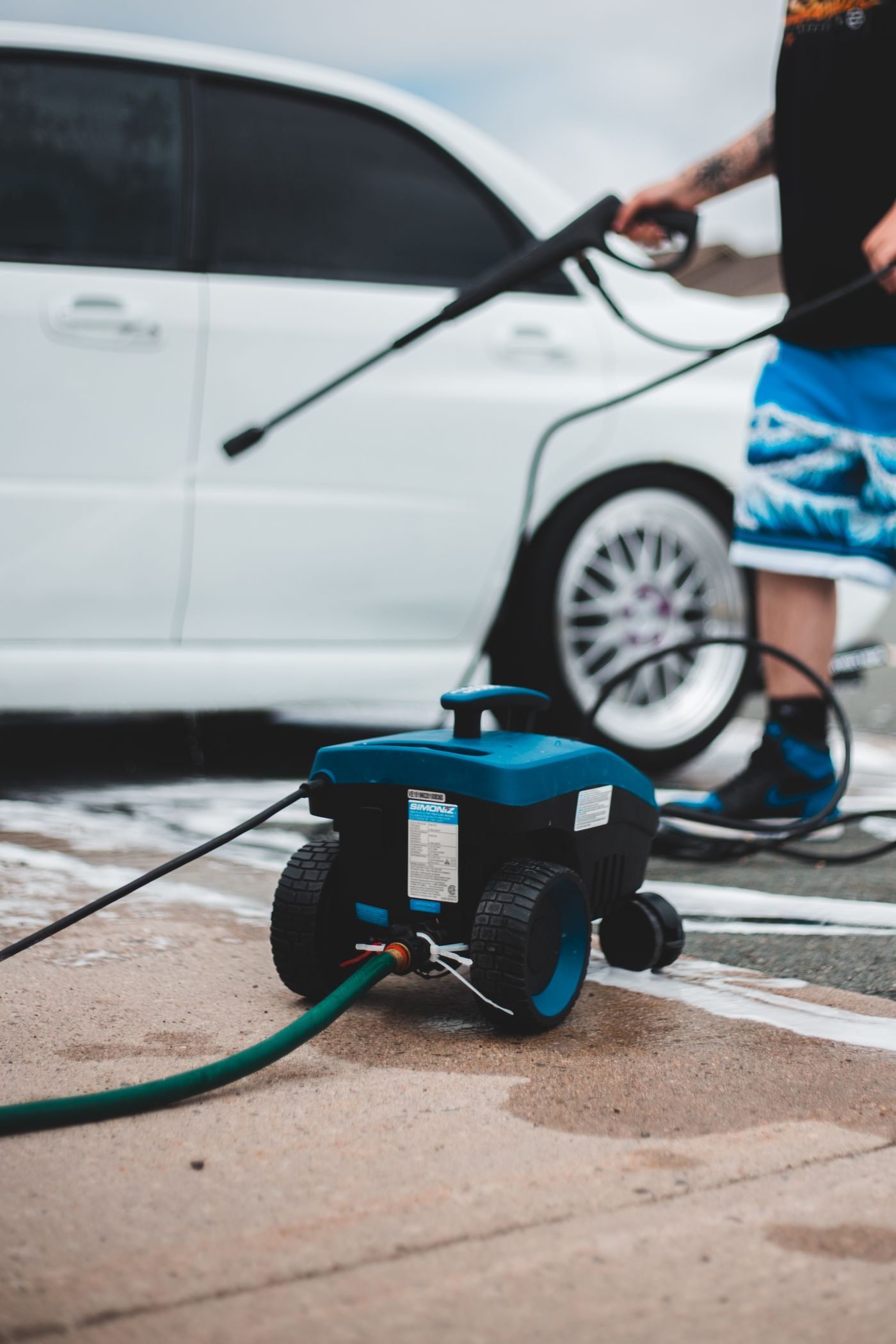 A freshly pressure-washed concrete driveway in front of a South Florida home